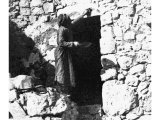 The Passover ritual of dipping a bunch of hyssop in the blood of the sacrifice and sprinkling it over the entrance to the tent or dwelling place. An early photograph.